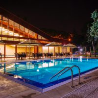 Picture of well lit pool and house